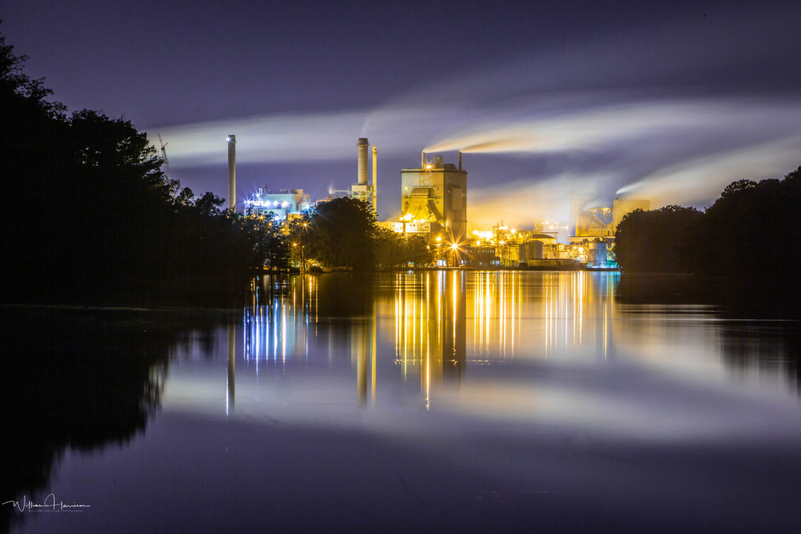Domtar is committed to water conservation and responsible water management at our mills. Image: Plymouth Mill exterior on river, nighttime.