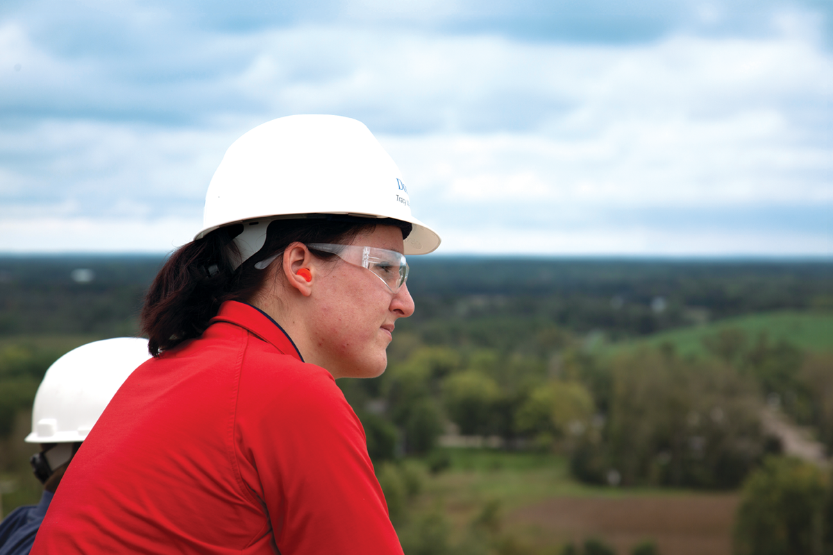 Image: People in hard hats overlooking a forested landscape. We're committed to taking climate action by decarbonizing our operations, products and value chain. Read more in the Domtar sustainability report at sustainability dot domtar dot com.