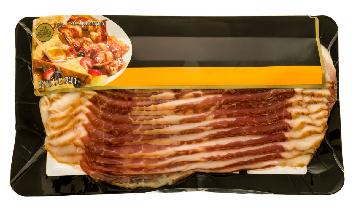 Bacon strips packaged on top of bacon board
