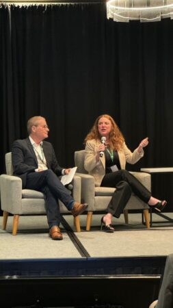 Paige Goff is speaking on stage an an event.