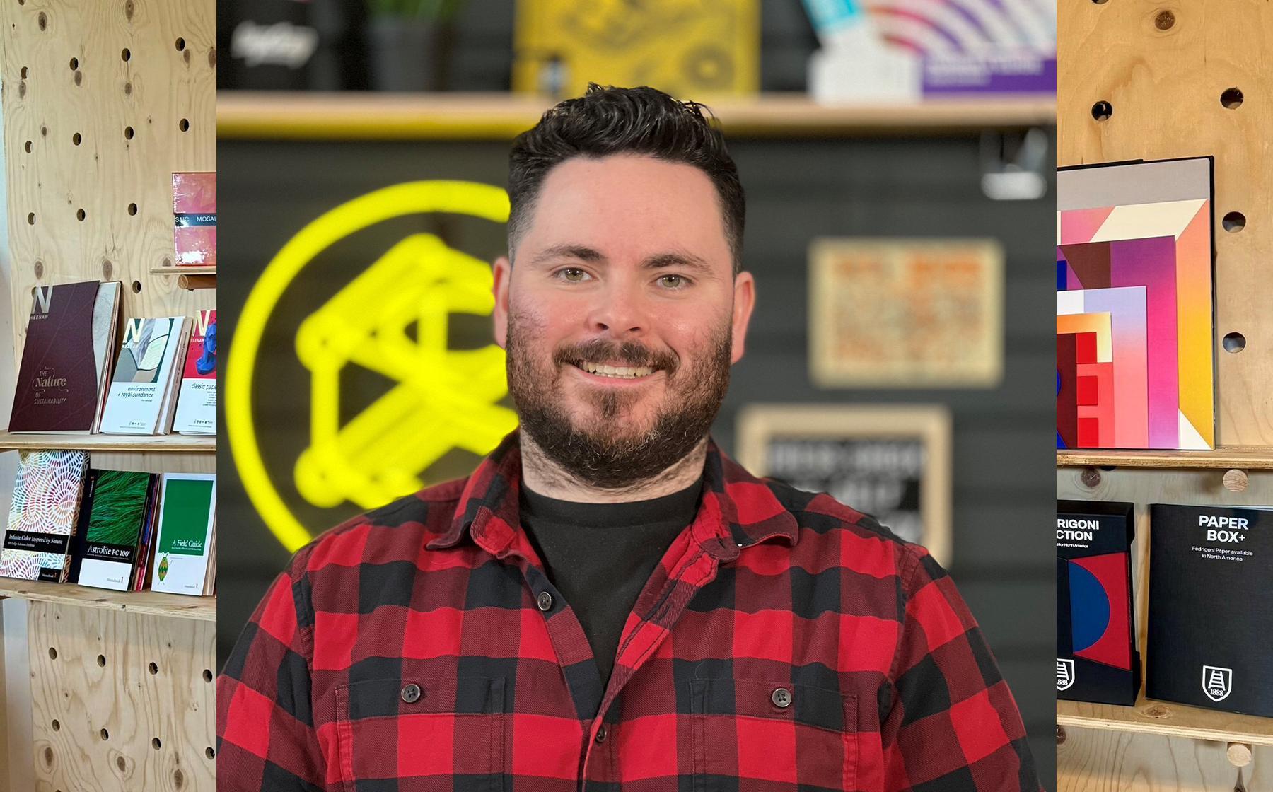 Dave Hopkins, the Print Design Academy founder who helps others with understanding print, is pictured in front of printed materials.