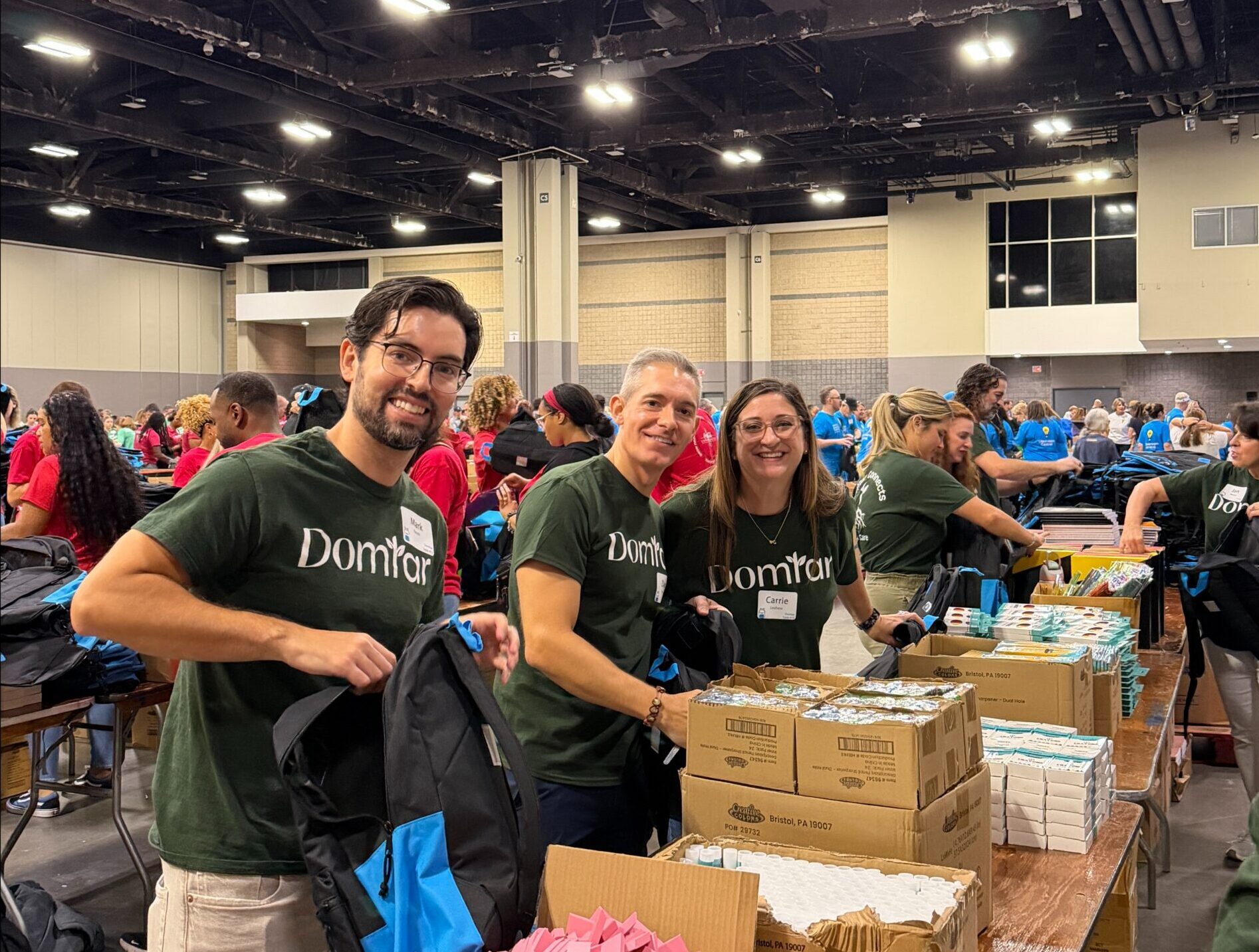 Domtar employees from Fort Mill, SC, packing backpacks.